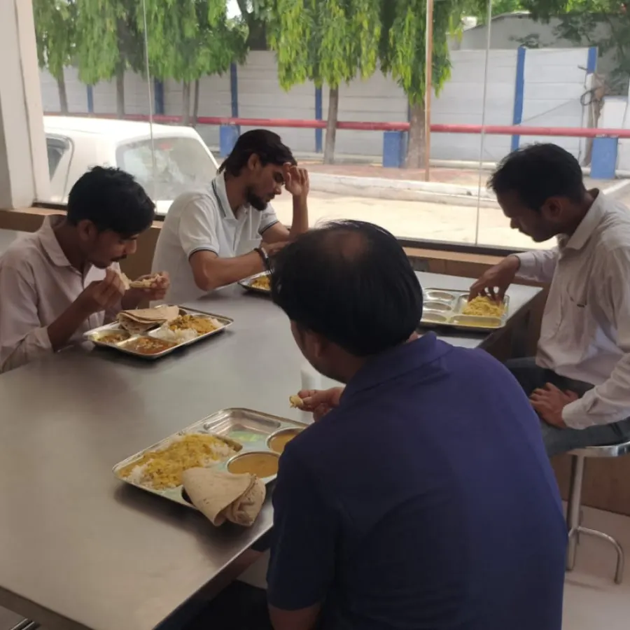 Workers having meals at the community canteen